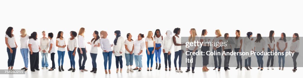 Diverse women standing in a row and talking