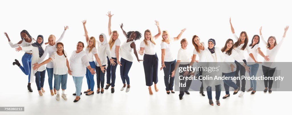 Portrait of diverse women standing in a row and celebrating