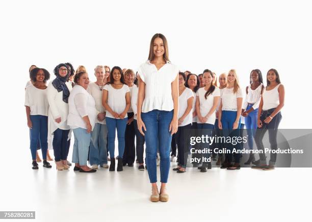 portrait of woman standing out from the crowd - crowd looking into camera happy indian stock-fotos und bilder