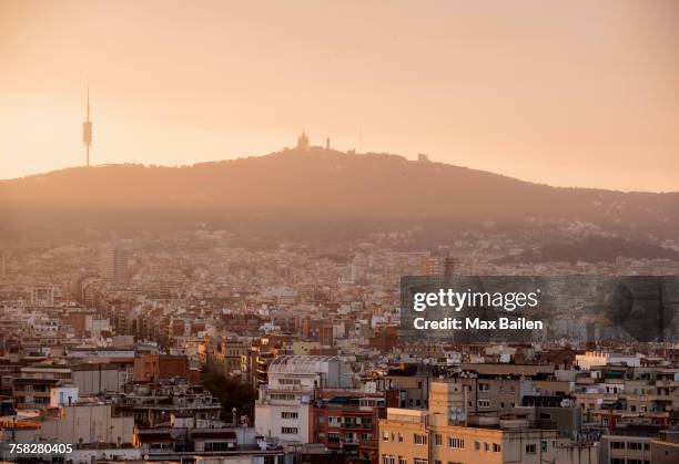 elevated hazy cityscape with distant view of montjuic, barcelona, spain - montjuic stock pictures, royalty-free photos & images