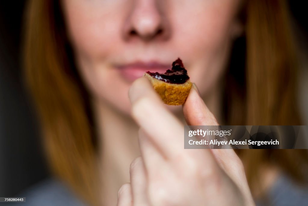 Close up of woman holding bread with jam