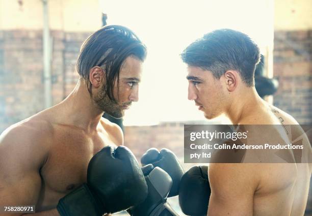 confident hispanic boxers face to face in gymnasium - boxing young men stock pictures, royalty-free photos & images