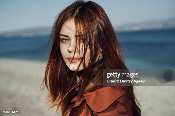 wind blowing hair of caucasian woman at beach - human hair strand stock pictures, royalty-free photos & images