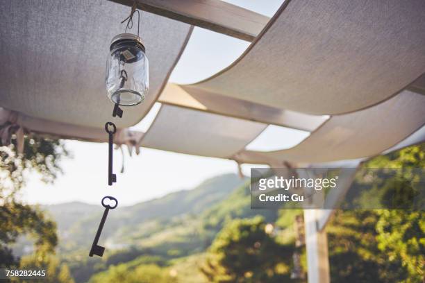 key wind chime hanging from patio rafter, lucca, tuscany, italy - wind chime stock pictures, royalty-free photos & images