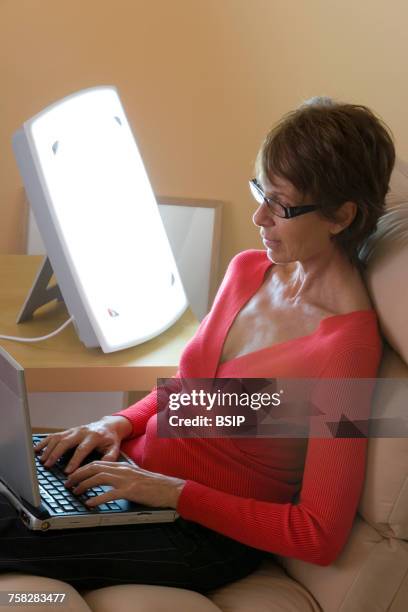 woman light therapy - winter blues stock pictures, royalty-free photos & images