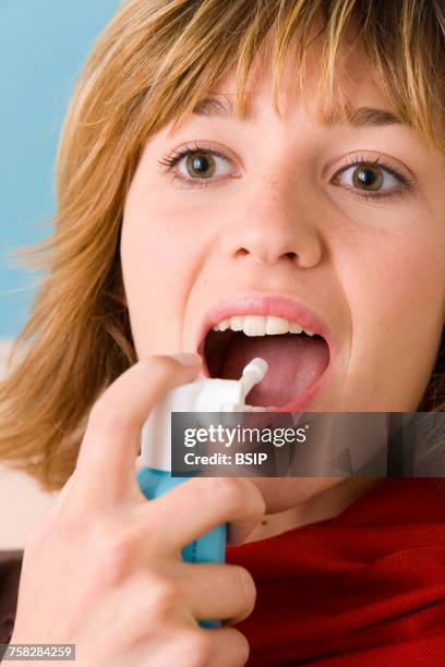 woman using spray in mouth - mouth spray stock pictures, royalty-free photos & images