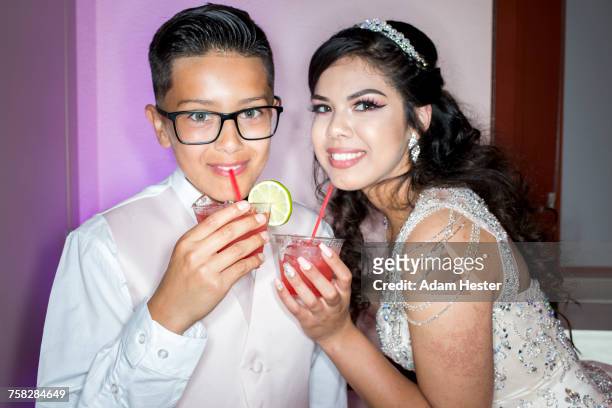 hispanic boy and girl drinking beverages with straws - boy tiara stock pictures, royalty-free photos & images