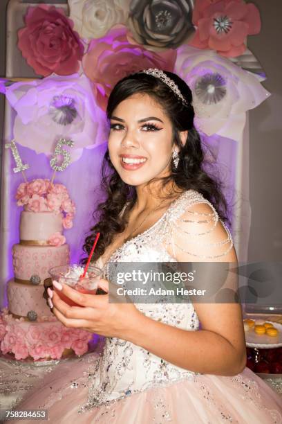 hispanic girl wearing gown drinking beverage with straw - quinceanera party stock pictures, royalty-free photos & images