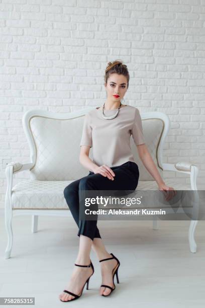 portrait of glamorous middle eastern woman sitting on bench - glamour fotografías e imágenes de stock