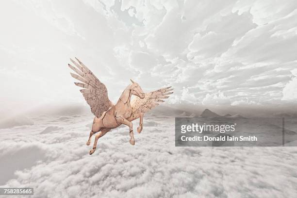 cracked horse flying in clouds - pegasus stock-fotos und bilder
