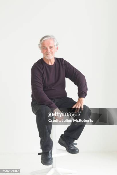 older caucasian man sitting on stool - front on portrait older full body stock pictures, royalty-free photos & images