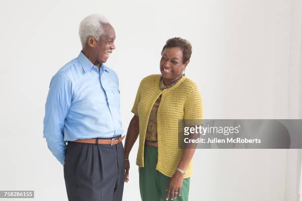portrait of older black couple laughing - three quarter length stockfoto's en -beelden