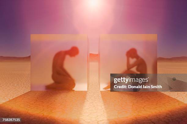 separated couple in suspended animation in desert - hot wife stockfoto's en -beelden