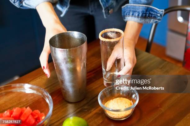 woman preparing cocktail - salt shaker stockfoto's en -beelden