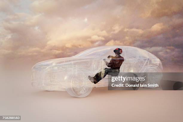 man wearing virtual reality helmet driving car - future car stock-fotos und bilder