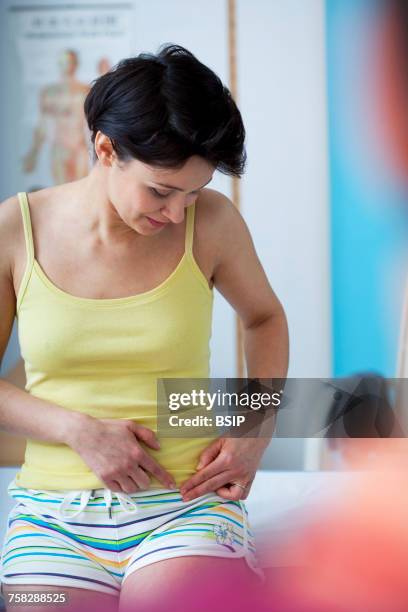 consultation,woman in pain - inguinal hernia stock pictures, royalty-free photos & images