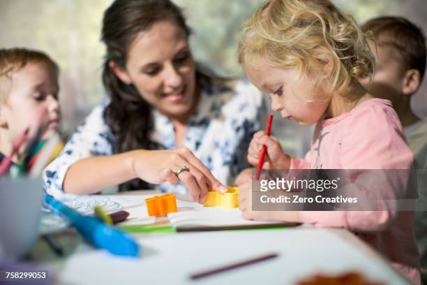 teacher and children drawing - nursery school child fotografías e imágenes de stock
