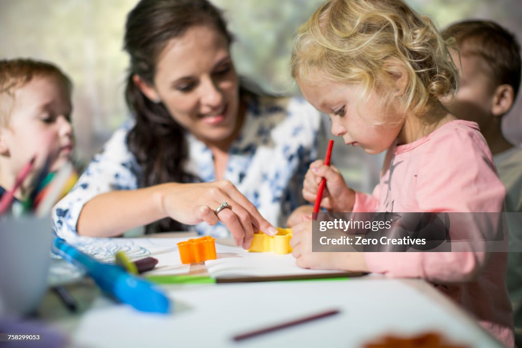 Teacher and children drawing