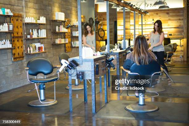 hairstylist working in salon - hair salon interior stock pictures, royalty-free photos & images