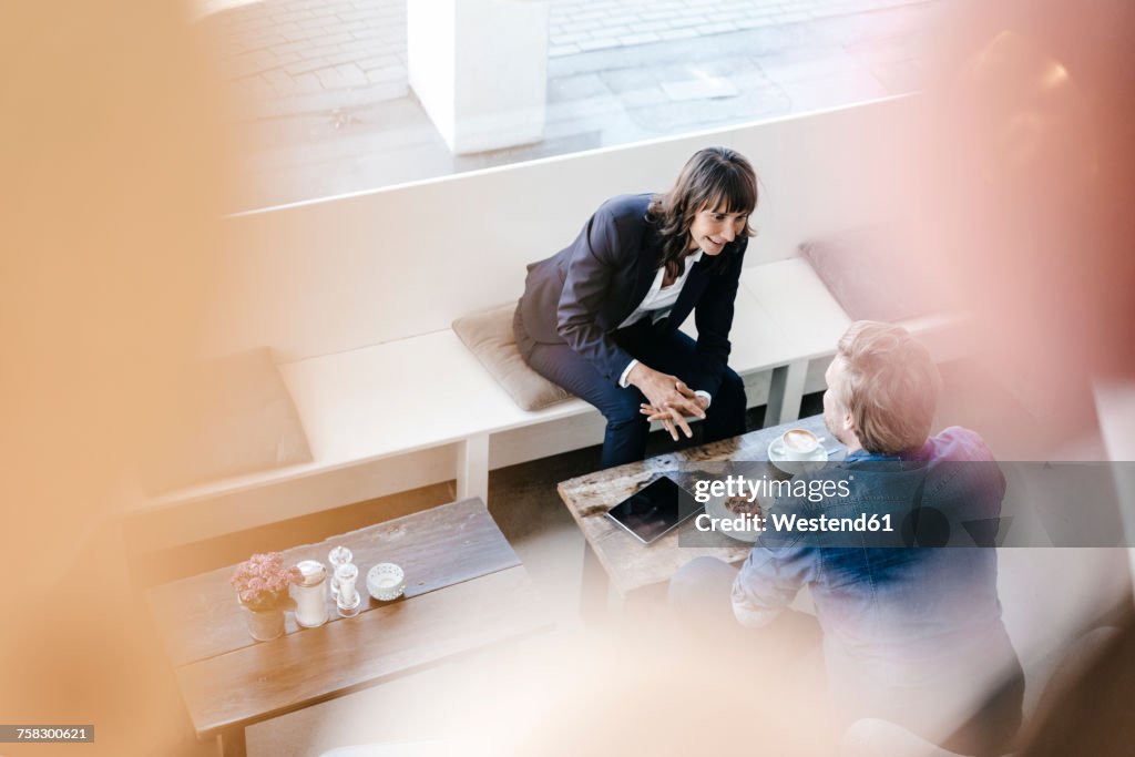 Businesswoman having a meeting with client in a cafe