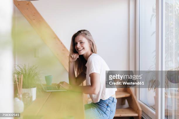 young woman at home using laptop - student stock-fotos und bilder