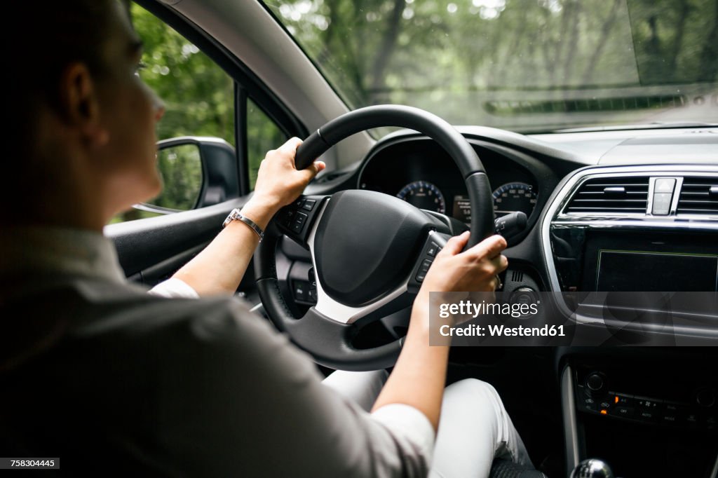 Back view of woman driving car