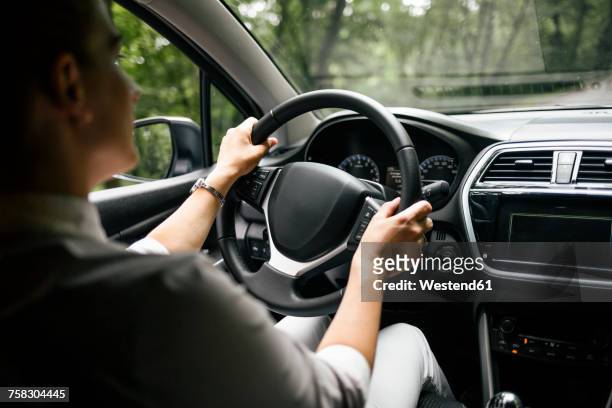 back view of woman driving car - steering wheel 個照片及圖片檔