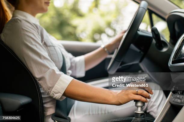 businesswoman driving car, partial view - gear shift stock pictures, royalty-free photos & images