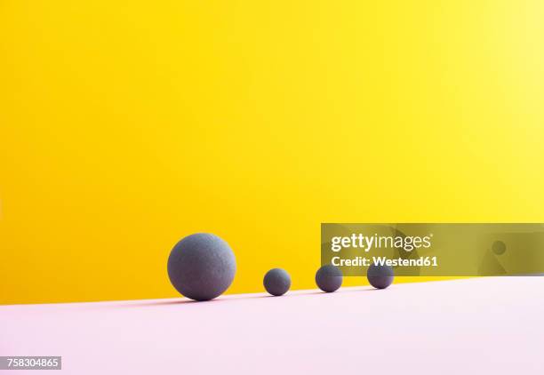 stockillustraties, clipart, cartoons en iconen met four spheres against yellow background, 3d rendering - schaal begrippen