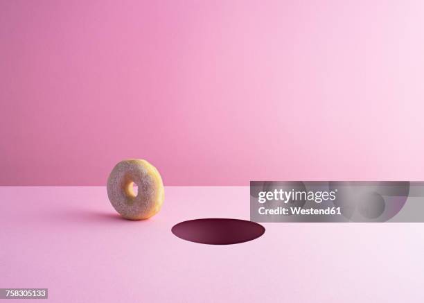 doughnut and hole on pink ground - loch stock-grafiken, -clipart, -cartoons und -symbole