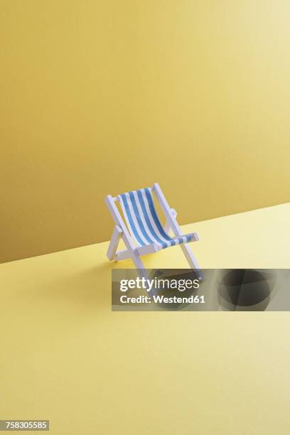 single beach chair on yellow ground, 3d rendering - empty seats stock illustrations