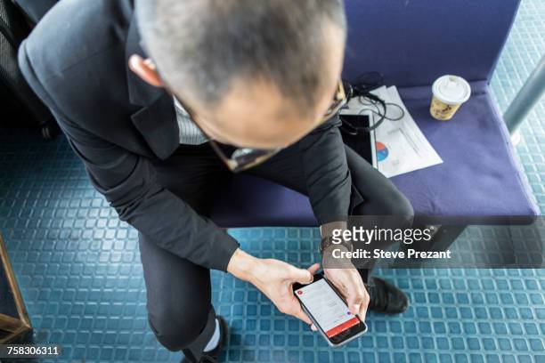 businessman on passenger ferry looking at smartphone - commuter ferry stock pictures, royalty-free photos & images