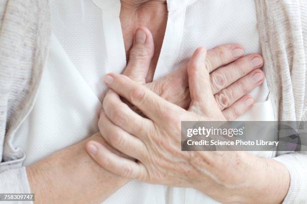 Senior Woman Holding Chest, Foto stock