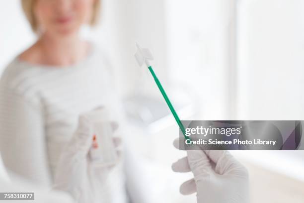doctor holding cervical smear equipment - cervical pap smear stock pictures, royalty-free photos & images
