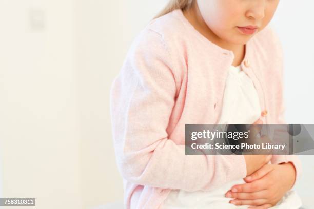 young girl with tummy ache - belly rub stockfoto's en -beelden