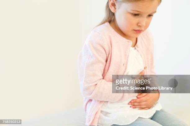 young girl with tummy ache - stomach child stock pictures, royalty-free photos & images