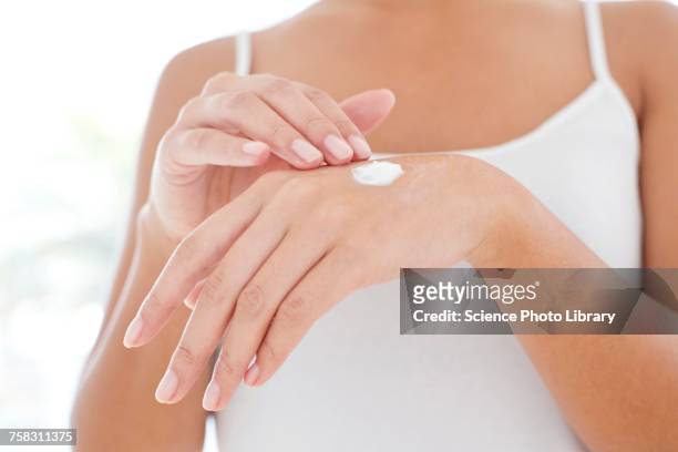 woman applying hand cream - hand cream 個照片及圖片檔