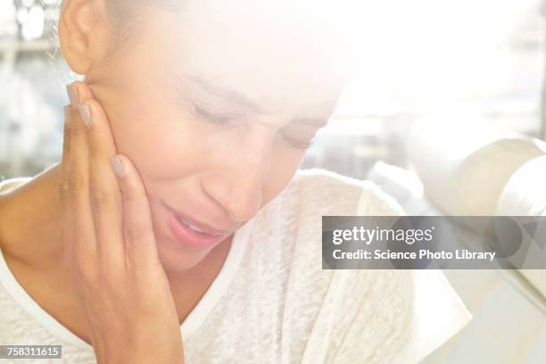 woman touching face in pain - tooth ache stock pictures, royalty-free photos & images