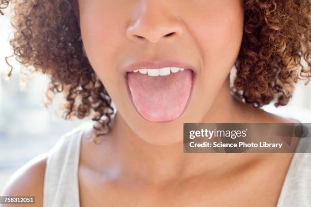 portrait of woman sticking out tongue - human tongue foto e immagini stock