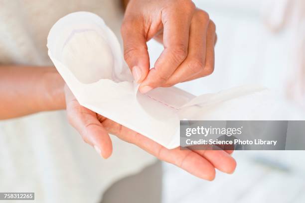woman holding sanitary towel - damenbinde stock-fotos und bilder