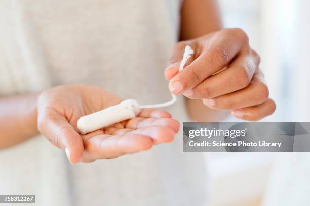 woman holding tampon - tampon stock pictures, royalty-free photos & images