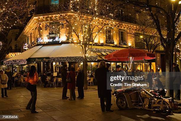 Roasted chestnut street seller outside Les Deux Magots Cafe and Restaurant, Boulevard St Germain, Paris, France