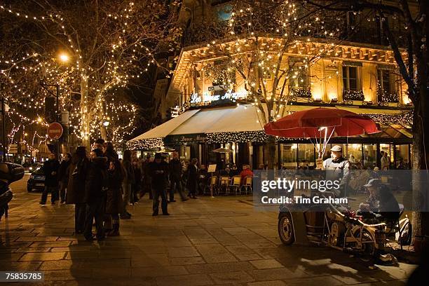 Roasted chestnut street seller outside Les Deux Magots Cafe and Restaurant, Boulevard St Germain, Paris, France