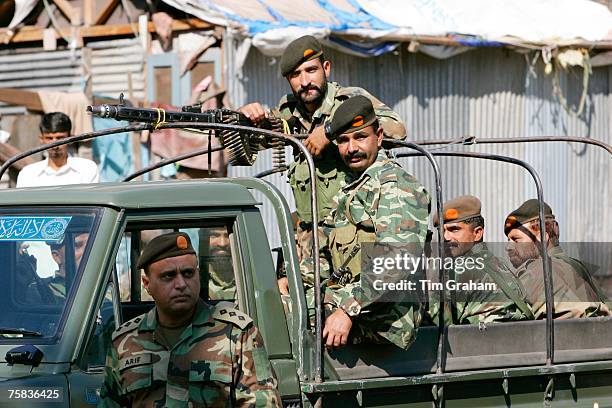 Armed Pakistani soldiers in open top vehicle with machine gun in village of Pattika, Pakistan