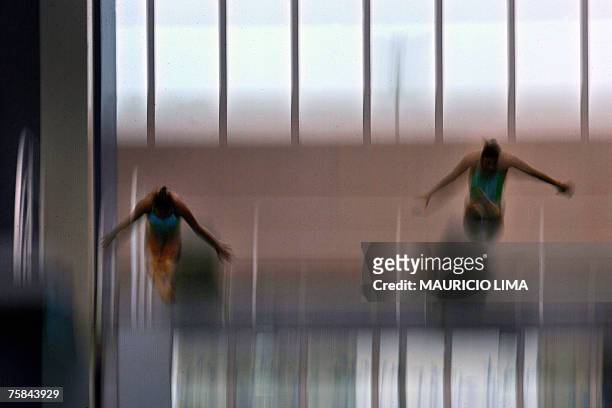 Brazil's Tammy Takagi and Juliana Veloso perform during the XV Pan American Games rIO-2007 diving 3m synchro springboard final, in Rio de Janeiro,...