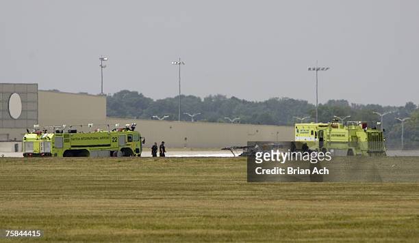 Wreckage and emergency response vehicles on the runway at the 2007 Vectren Dayton International Airshow at Dayton International Airport on July 28 in...