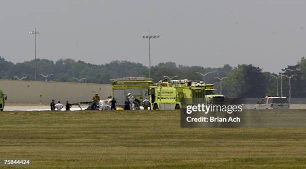 Wreckage and emergency response vehicles on the runway at the 2007 Vectren Dayton International Airshow at Dayton International Airport on July 28 in...