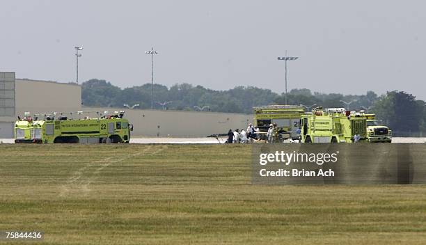 Wreckage and emergency response vehicles on the runway at the 2007 Vectren Dayton International Airshow at Dayton International Airport on July 28 in...