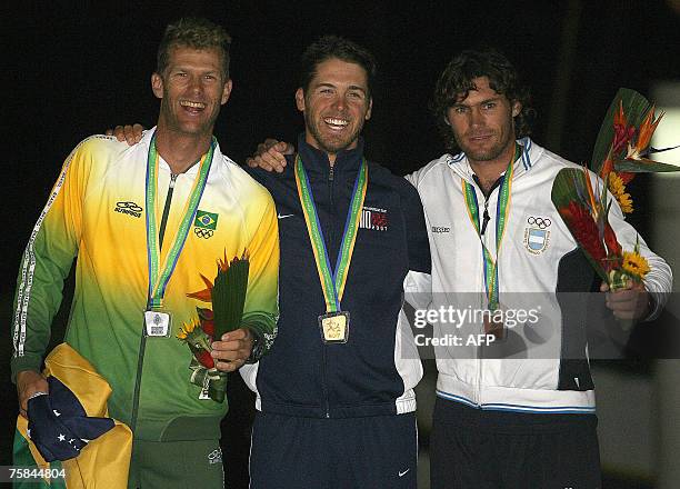 Laser sailing class athletes Brazilian Robert Scheidt -Silver medal-, US Andrew Campbell -Gold- and Argentine Julio Alsogaray -Bronze-, pose at the...