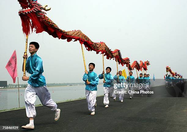 Artists carry dragons during the offical opening of the Shunyi Olympic Rowing-Canoeing Park on July 28, 2007 in Beijing, China. The venue, built for...